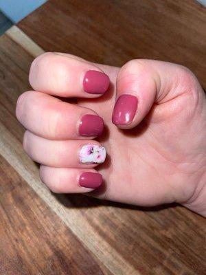 A nice acrylic overlay on natural nails with mauve gel polish and a floral transfer design