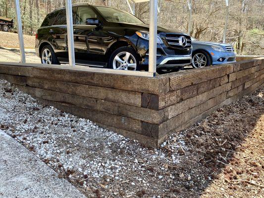 raised carport with rr tie retaining wall