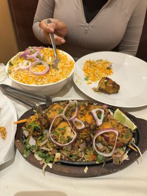 Chicken Tikka Kebab and Golkonda Lamb Biryani. Chicken Lollipop and Onion Pakora. Mango Lassi.