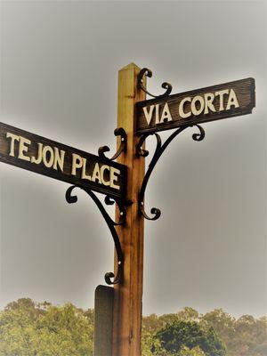 On the corner of "Tejon Place & Via Corta"