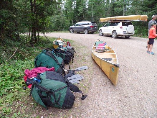 Waiting for pickup - portage packs and canoes