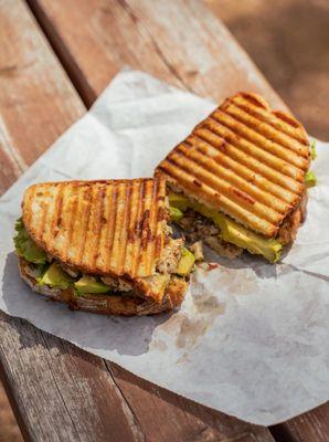 The Panini 
Grilled Italian bread with southwest chicken , bacon, smoked Gouda, fresh-cut avocado, ranch.