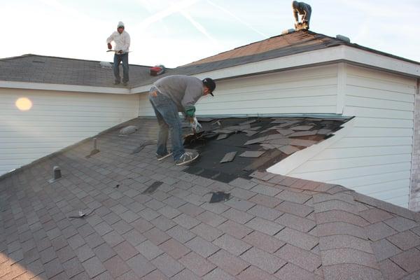 This is how it all starts, with tearing off the existing shingles.