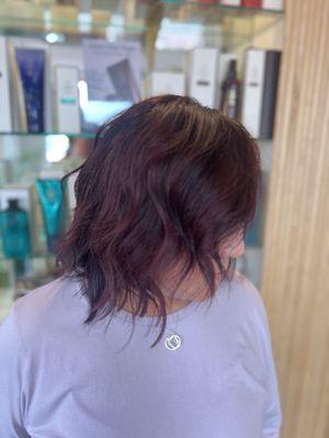 Customized hand painted burgundy balayage and haircut