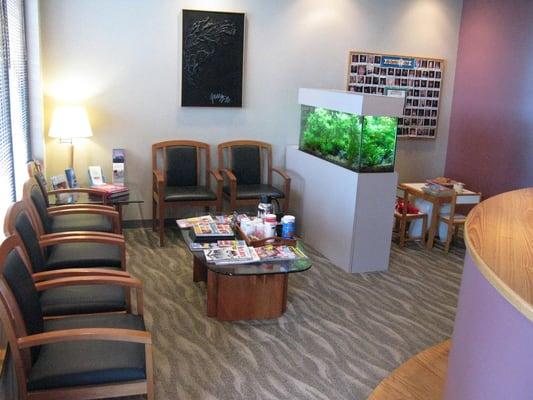 Comfortable reception area with current magazines, coffee and water, and an aquarium.