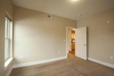 Carpeted bedroom in Two Bedroom apartment.