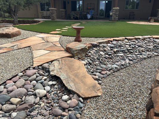 Flagstone walkway, artificial grass, gravel ,boulders the whole 9 yards!