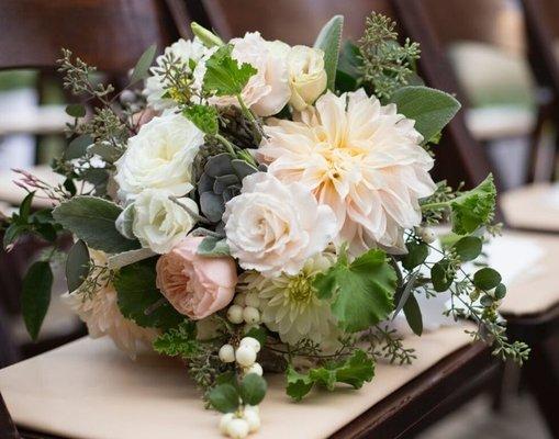 Bridal bouquet of white roses, pale pink roses, succulents, berries,