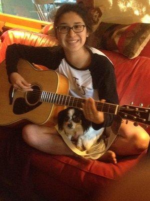 Student and dog enjoying their music lessons.