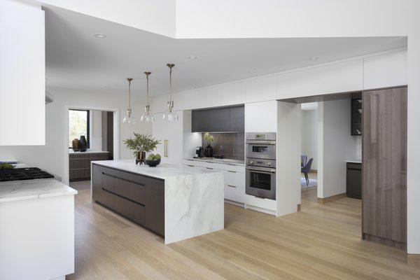 Contemporary design needn't be cold and stark; this kitchen is a study in blending tones, patterns, and finishes to dazzle at every turn.