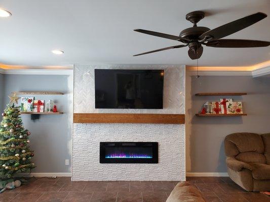 Beautiful tile job, custom mantel and floating shelves