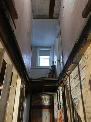 Gaping hole they from dirt floor basement, through the uninsulated demo area, into the 2nd floor where the bedrooms and bathroom were.