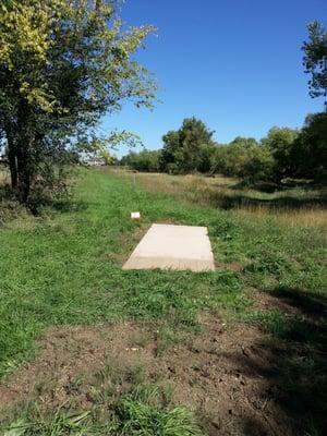 Hole 9 from behind the tee.  Basket is out of sight.