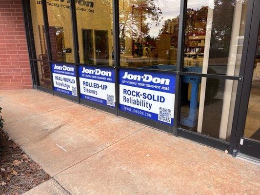 Signs in the front window that say rock-solid reliability at Jon-Don Atlanta