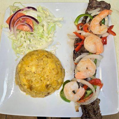 Steak with shrimp and fried mashed plantains