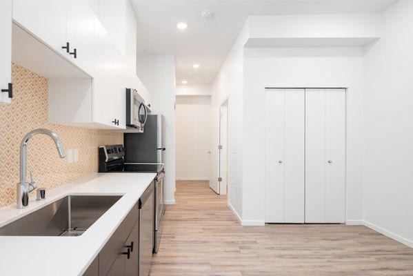 Kitchen looking into the hallway with wood-style flooring