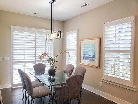 Wood plantation shutters with 4 1/2" louvers and a divider rail.