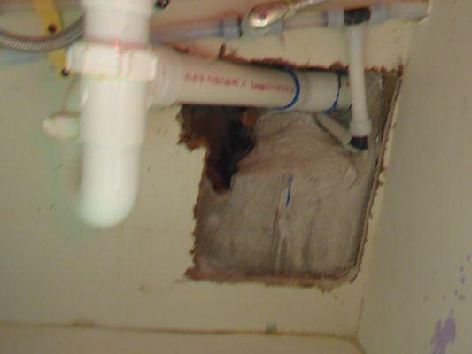 You can see the large open void in the concrete wall of my bathroom vanity wall. They made no attempt to repair their mistake.