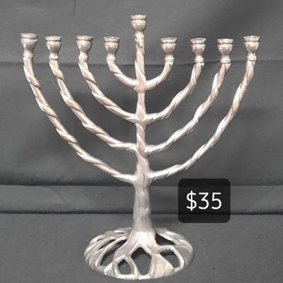 Beautiful menorah made from heavy metal. Measures 8.5"L x 9.5"H. $35