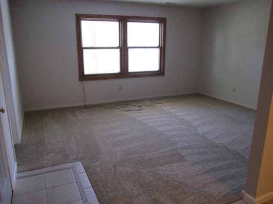 Large living room with double pane window and built-in solar shades.