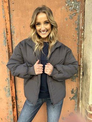 Grey Puffer Jacket with front zipper.