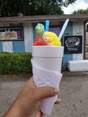 Rainbow snow cone with lollipop