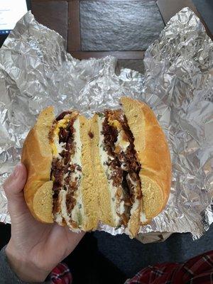 Bacon, egg, cheese, and scallion and chive cream cheese on an egg bagel