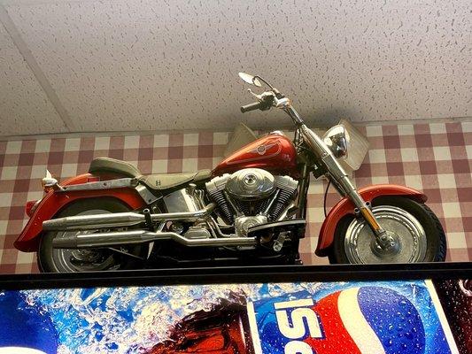 Motorcycle on top of drink cooler