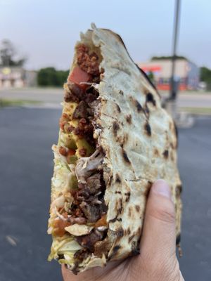 Tlayuda = thin crispy "pizza" tortilla filled with chorizo, carne asada, queso Oaxaquena, etc = classic street food of Oaxaca!!