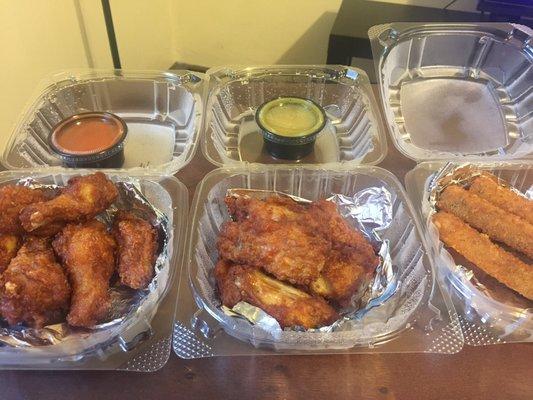 Wings with Buffalo sauce and garlic butter sauce and an order of provolone sticks