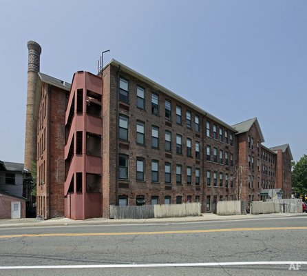 The main entrance located rear of building and parking lot of off Diller Avenue