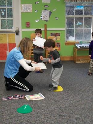 3 year old breaking a plastic board at Yogarate last class ceremony.