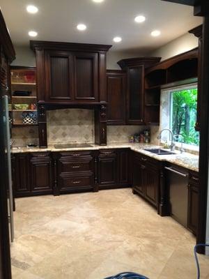 Kitchen with bump out granite at sink and cooktop.Light bridge over sink