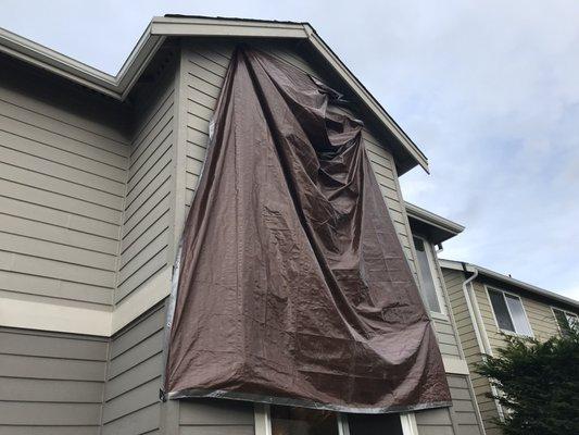 Storm damage repairs and tarp