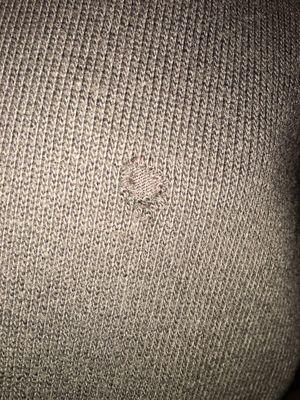 Hole front of sweater discovered after cleaning