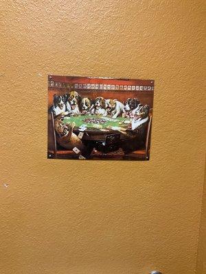 Dogs playing poker in men's bathroom.  Very funny & quaint.