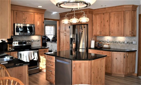 Gorgeous Natural Rustic Alder cabinetry by Omega Dynasty with Ubatuba granite tops.