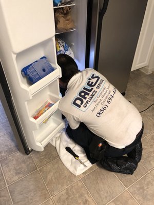 Mike repairing leaking freezer.