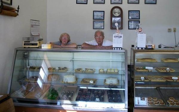 Magee and Hubby standing behind one of their cases 2013. You can see the Transparent Tarts and Pies in the right case.