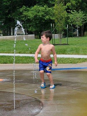 One of my grandkids running around on the splash pad