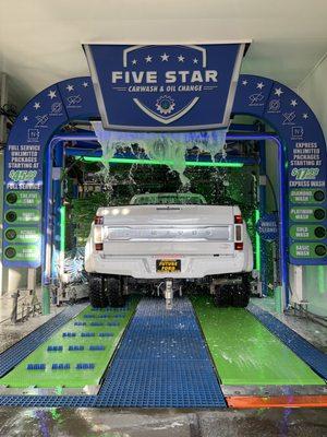 Dually truck going through the car wash.