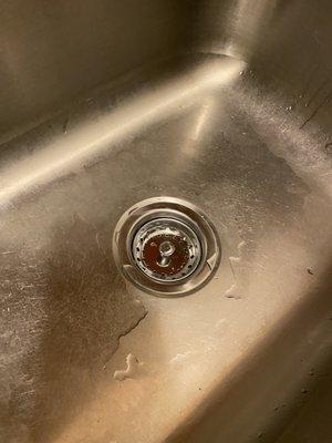 Kitchen sink that was leaking. This is after the plumber repaired it.