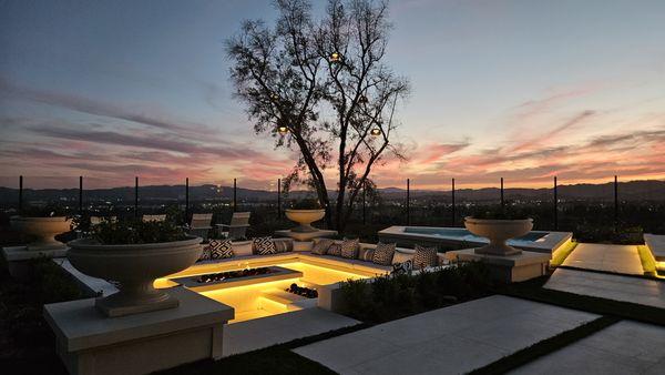 Sunken fire pit feature with olive tree and spa