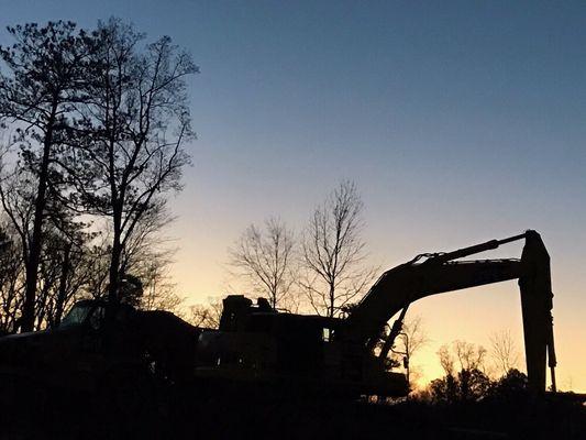 Backhoe loading one of our trucks full of fill dirt.