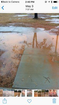 No lip at top of driveway to prevent water, no barrier to water coming in from the road.