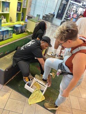 Me getting my suede Pumas cleaned up by Donovan. He was talkative and entertaining and good and cleaning shoes.