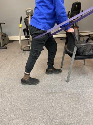 Band assisted hip extension to help with pain free walking and prolonged standing tolerance.