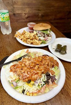 Chicken Istanbul salad bowl, stuffed grape leaves, and Farmer's Burger & fried potato