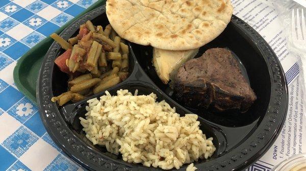 Lamb t-bone, rice, green beans, Spanakopita (spinach triangle) and pita. It's all very good.