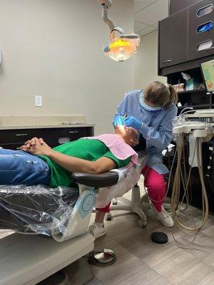 My husband getting her teeth's clean